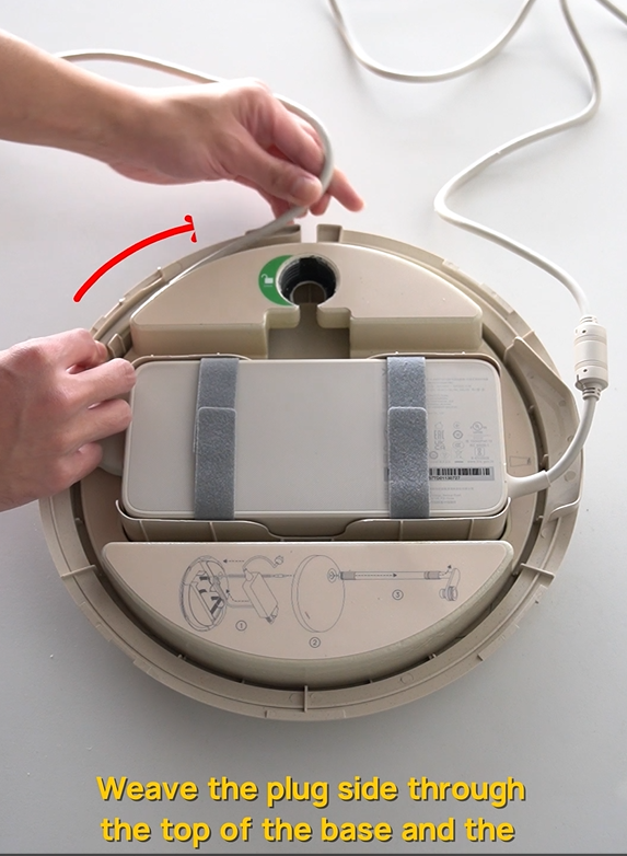 Weave the plug side through the top of the base and the connector side through the hole